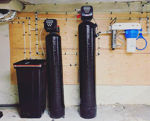 Water filtration and softening system installed in a residential basement.